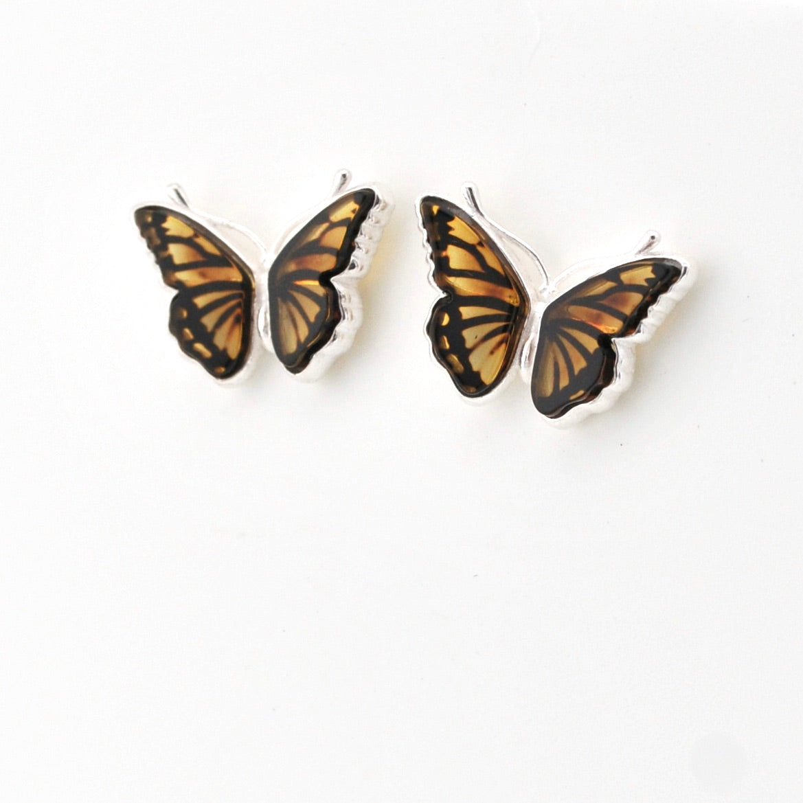 Amber butterfly post earrings on white background