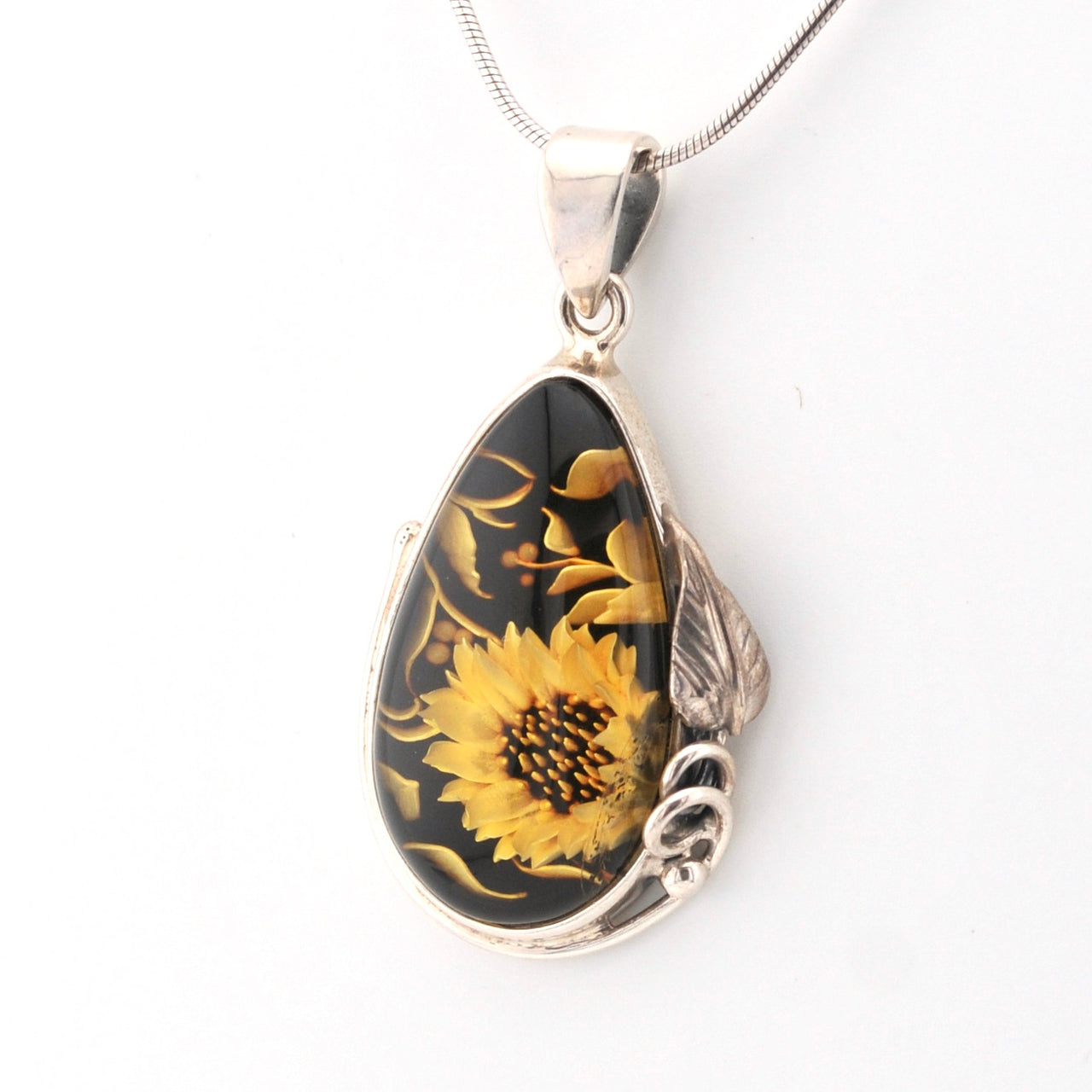 Teardrop-shaped pendant with sunflower design on a white background