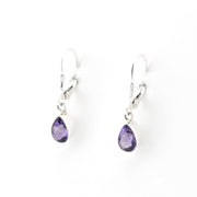 Pair of silver earrings with purple teardrop-shaped gemstones on a white background