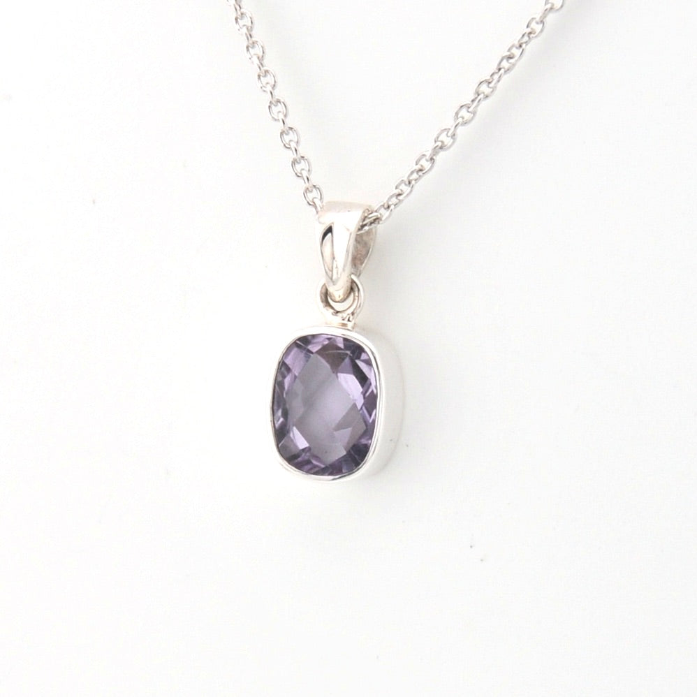 Purple gemstone pendant on a silver chain against a white background