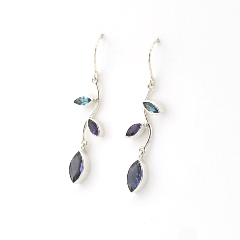 Silver earrings with blue and purple gemstones on a white background
