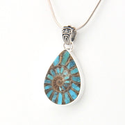 Teardrop-shaped pendant with blue and brown design on a white background