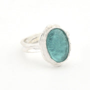 Silver ring with a green Roman glass on a white background