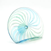Glass sculpture with swirling pattern on a white background