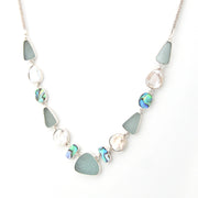 Necklace with blue and silver beads on a white background