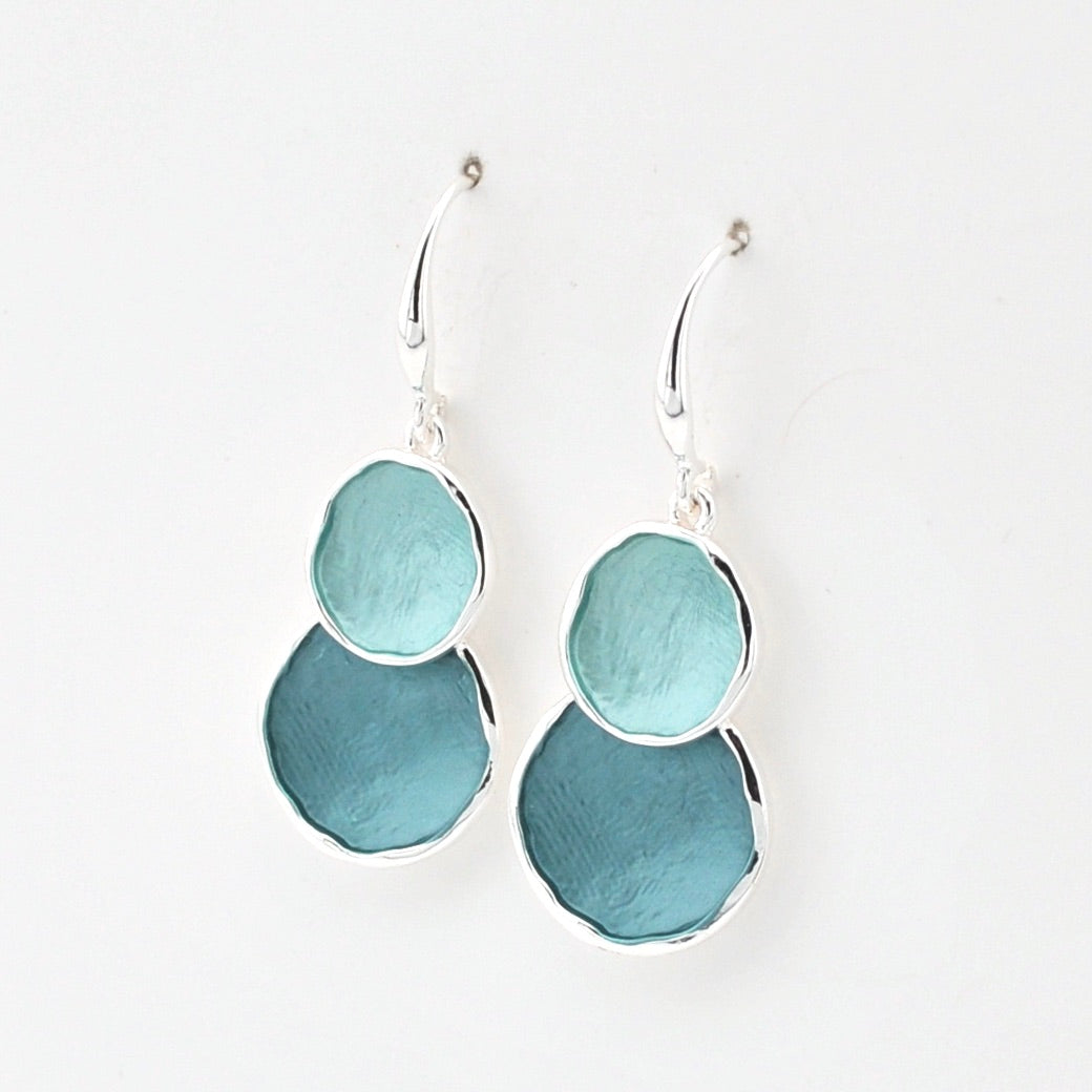 Pair of earrings with blue and silver design on a white background