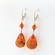 Pair of amber teardrop earrings on a white background