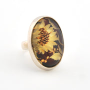 Ring with sunflower design on a white background