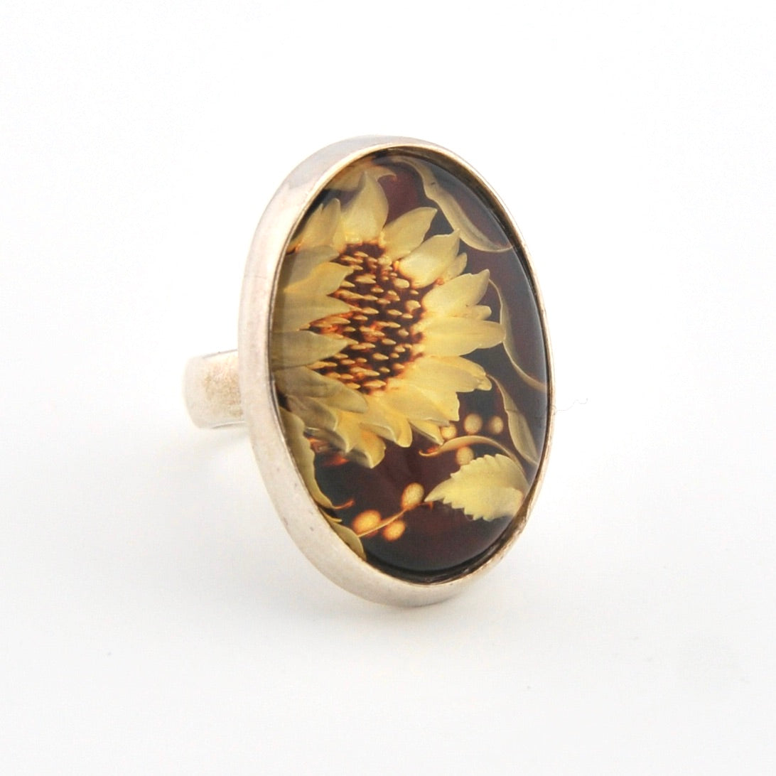 Ring with sunflower design on a white background
