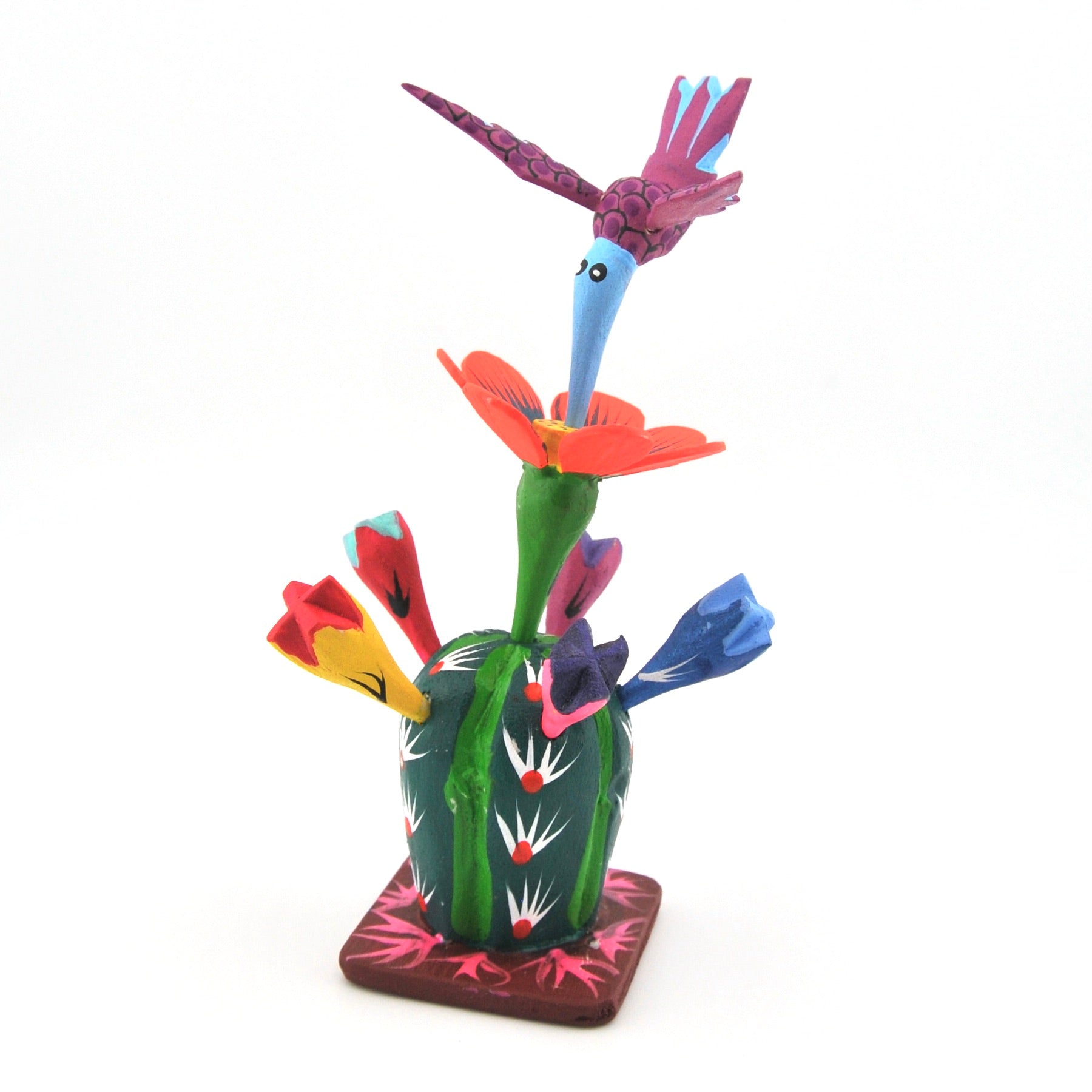 Colorful wood sculpture of birds and flowers on a white background