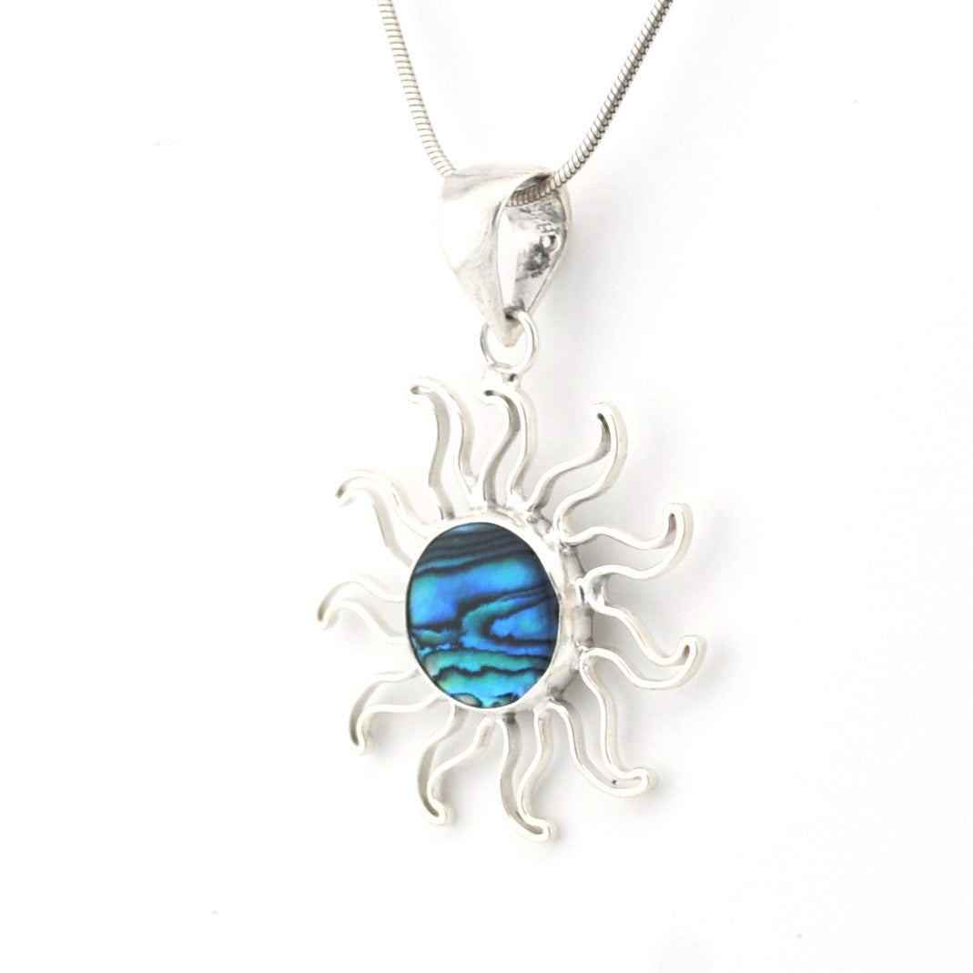 Sun-shaped pendant with blue center on a white background