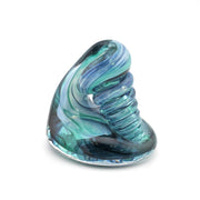 Glass sculpture with blue and green swirls on a white background