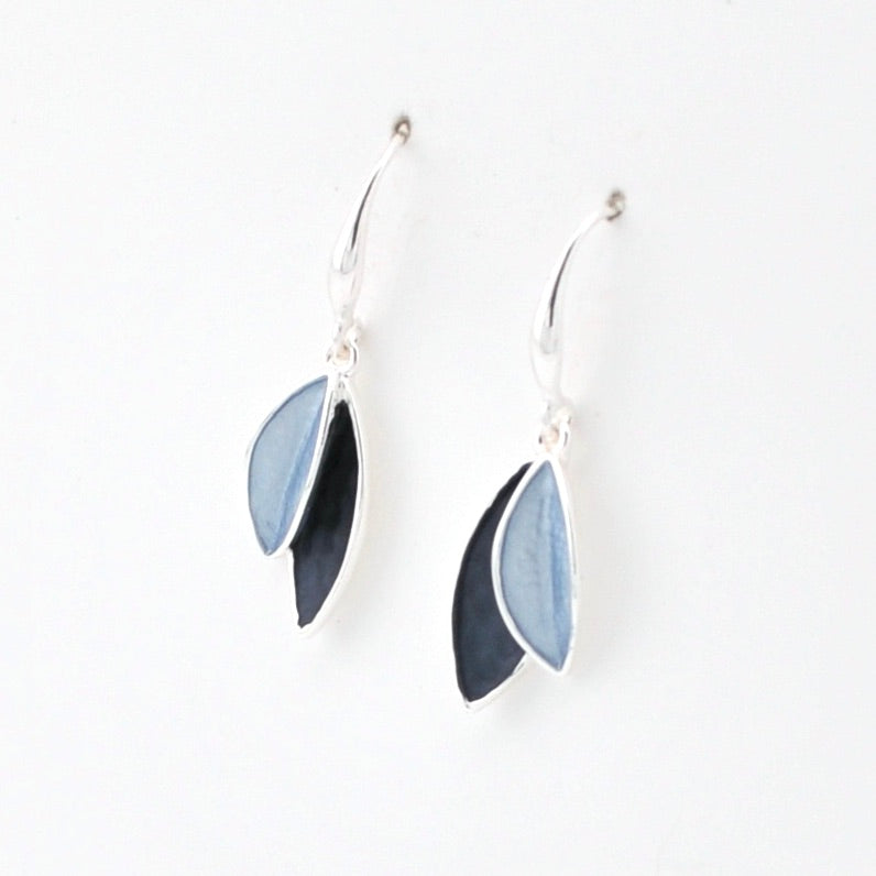 Pair of earrings with blue and black leaf-like designs on a white background