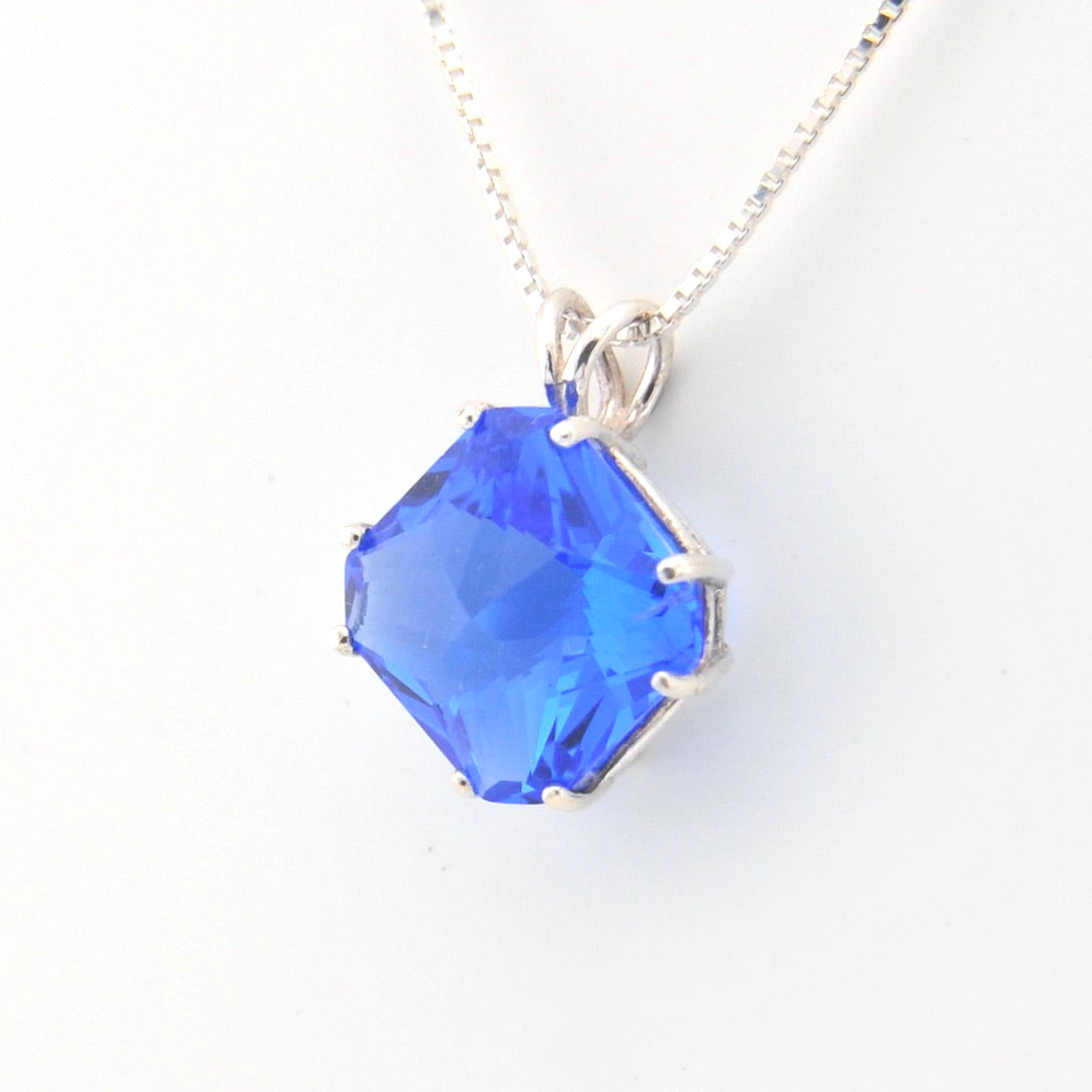 Blue gemstone necklace on a white background