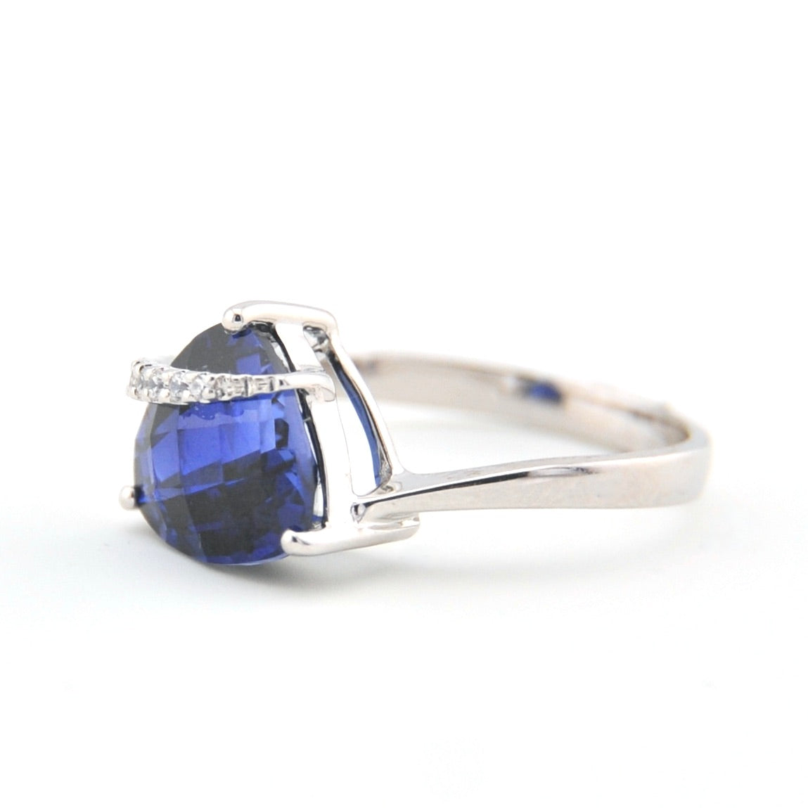 Silver ring with a blue gemstone on a white background