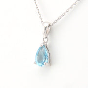 Teardrop-shaped blue gemstone pendant on a white background