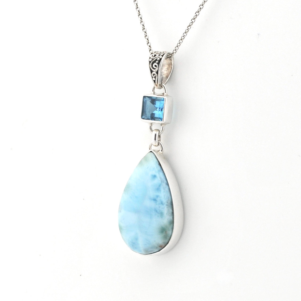 Necklace with a teardrop-shaped larimar pendant on a white background