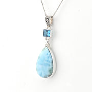 Necklace with a teardrop-shaped larimar pendant on a white background