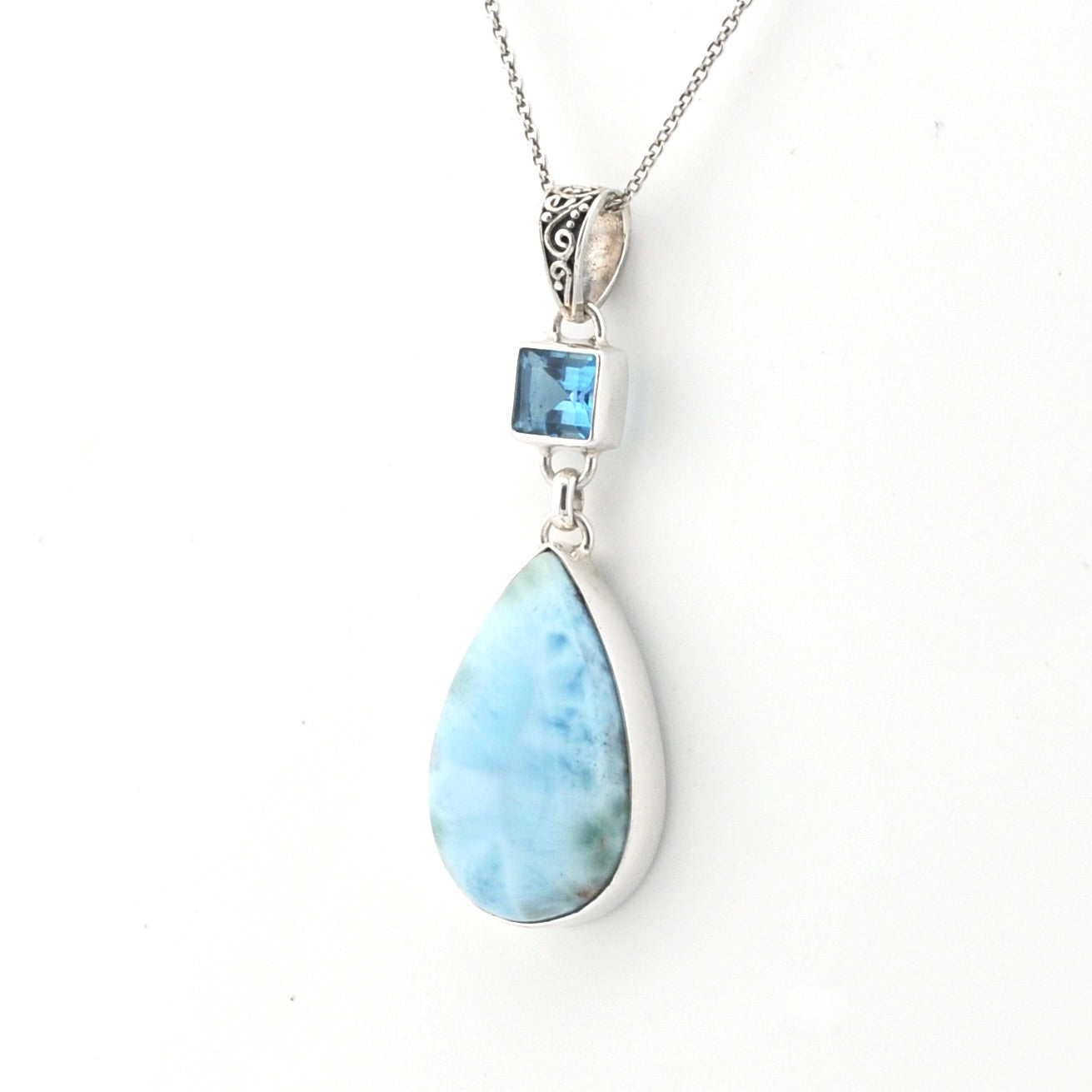 Necklace with a teardrop-shaped larimar pendant on a white background