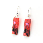 Red and black rectangular earrings on a white background