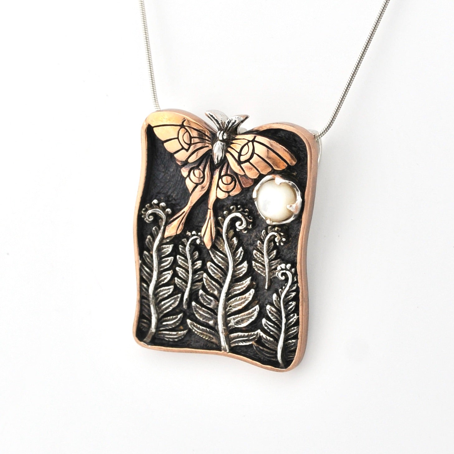 Necklace with a luna moth and leaf design pendant on a white background