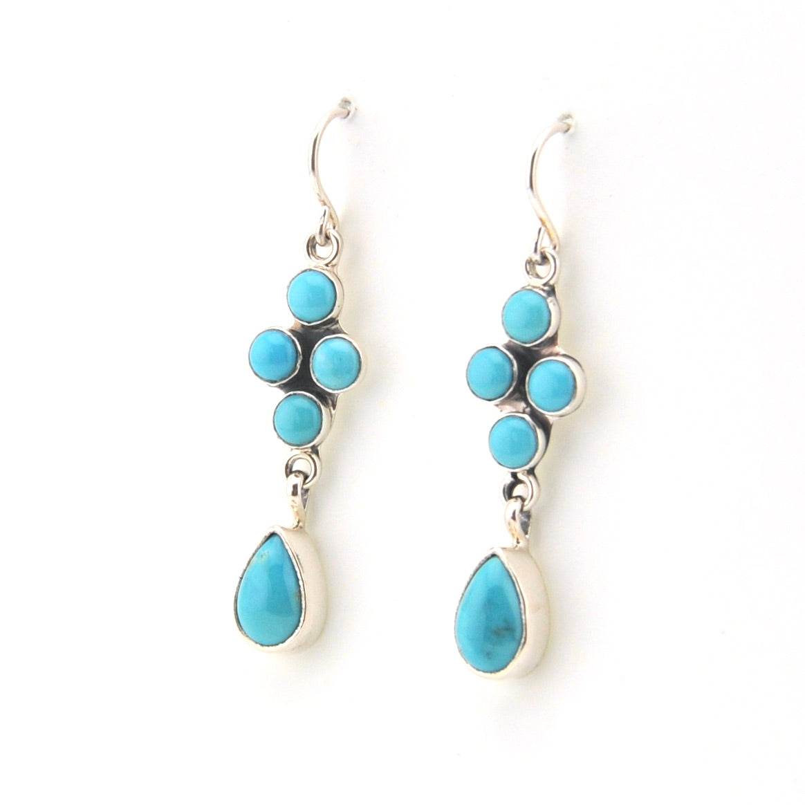 Turquoise earrings with silver hooks on a white background