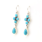 Turquoise earrings with silver hooks on a white background