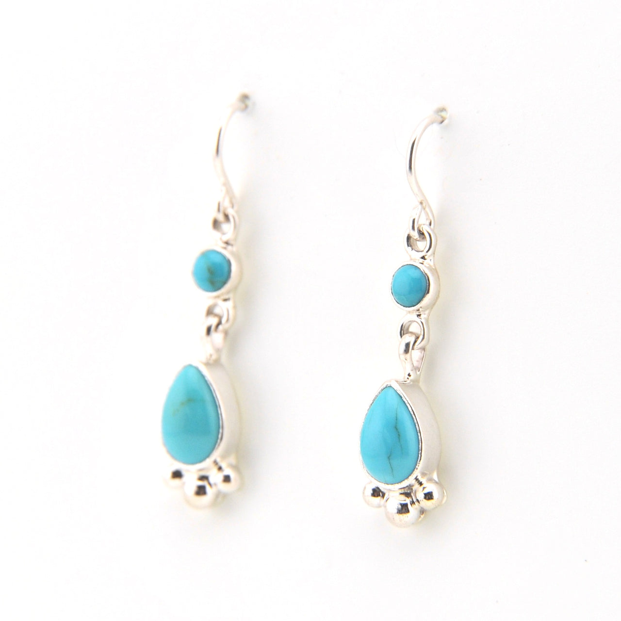 Turquoise teardrop earrings on a white background