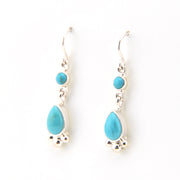 Turquoise teardrop earrings on a white background