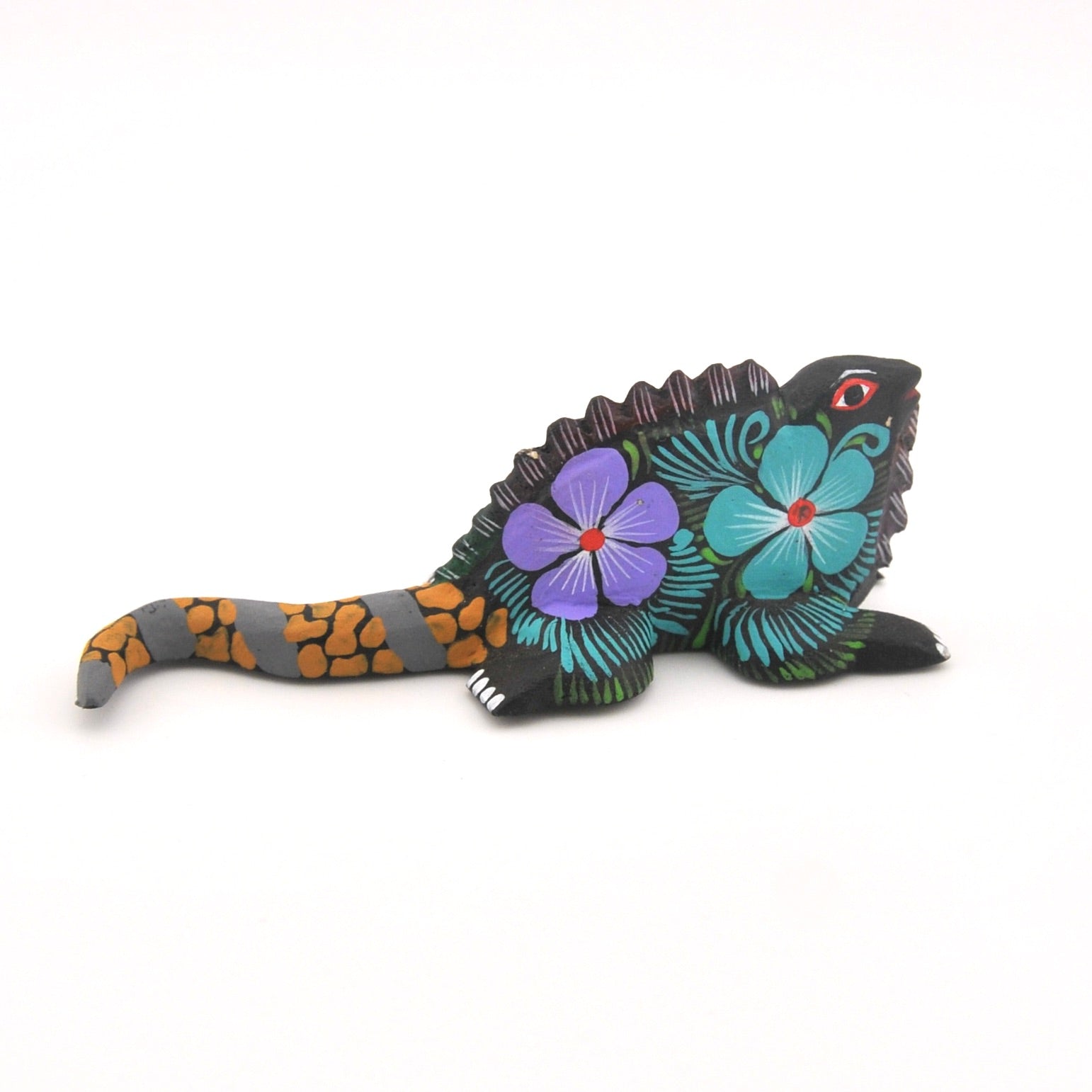 Decorative figurine of a lizard with floral patterns on a white background