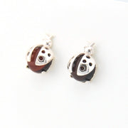 Pair of ladybug-shaped earrings with silver and brown design on a white background