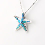 Star-shaped pendant with blue opal inlay on a white background