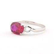 Silver ring with a pink gemstone on a white background