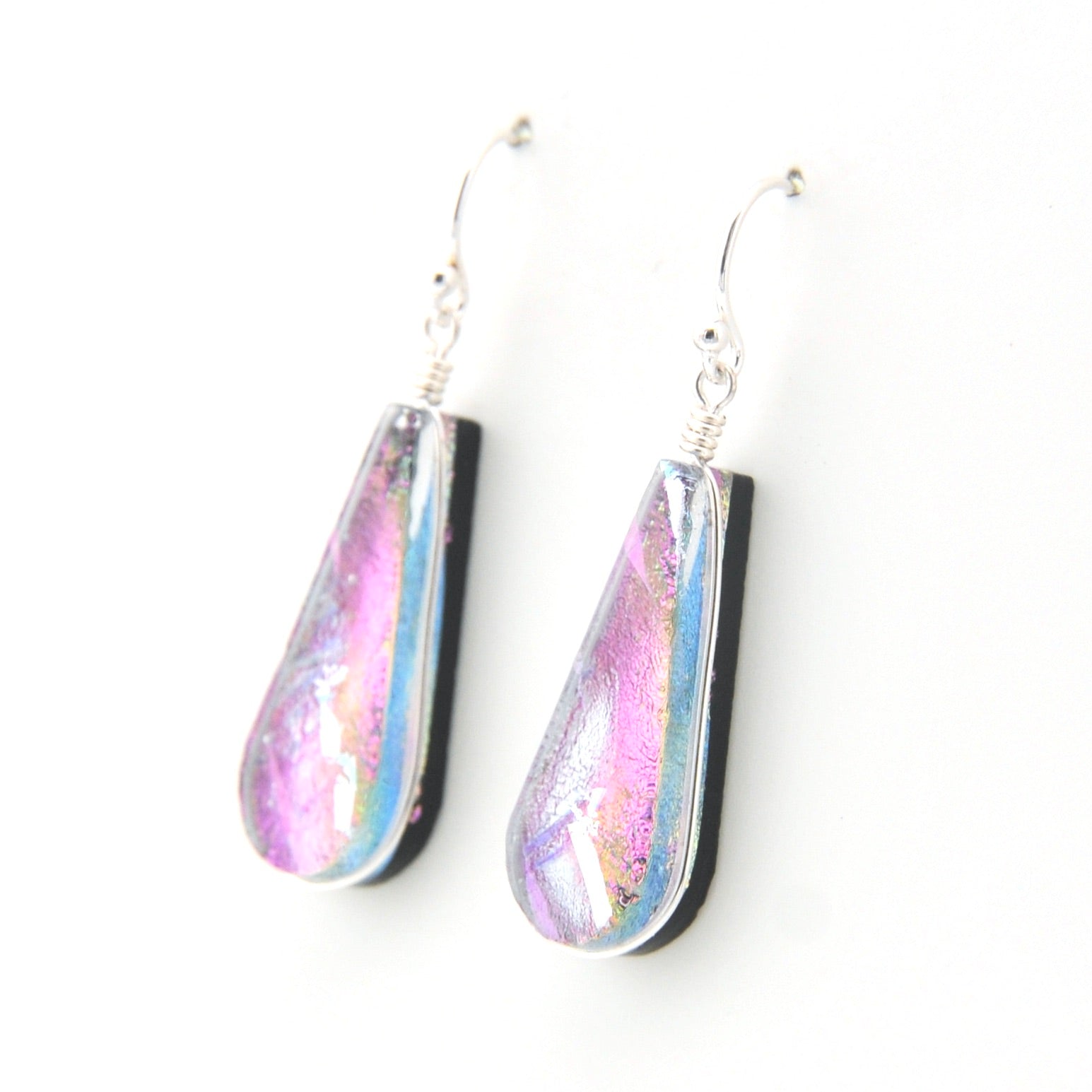 Teardrop-shaped earrings with iridescent finish on a white background