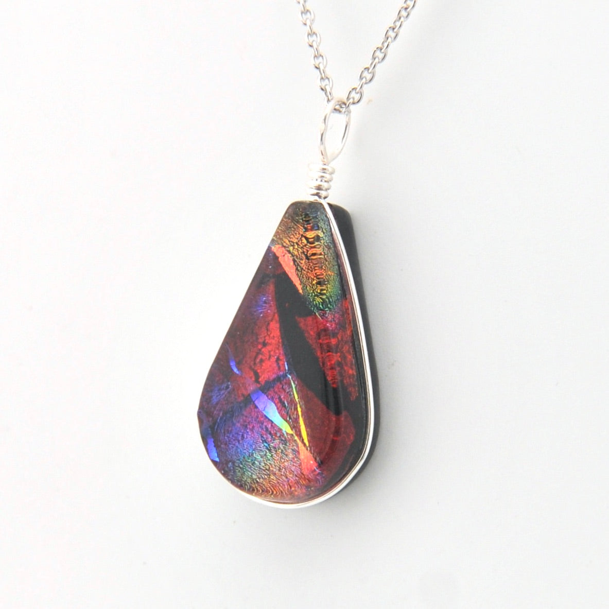 Multicolored teardrop pendant on a white background