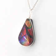 Multicolored teardrop pendant on a white background