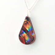 Teardrop-shaped pendant with multicolored iridescent finish on a white background