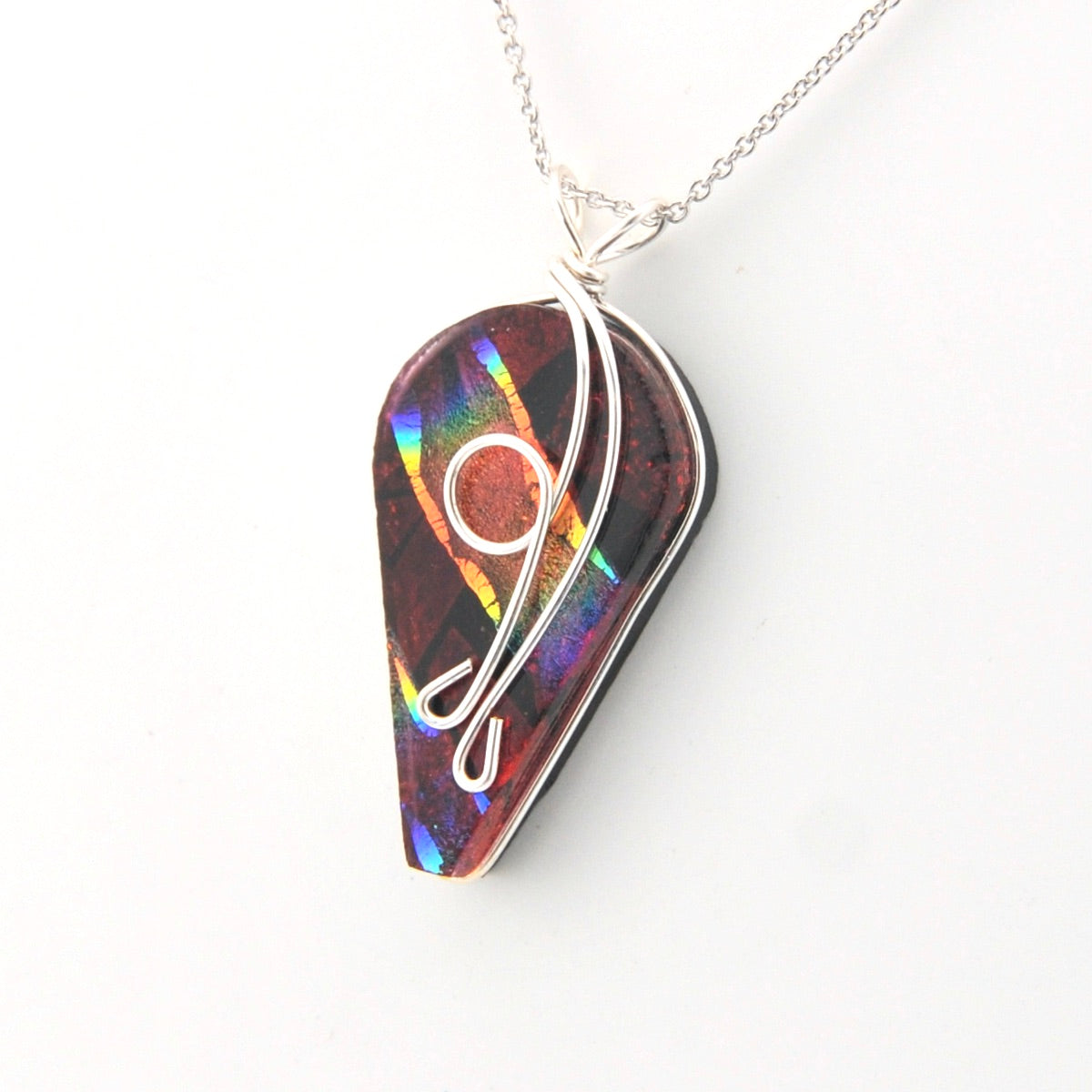 Multicolored pendant with a silver chain on a white background
