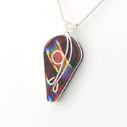 Multicolored pendant with a silver chain on a white background
