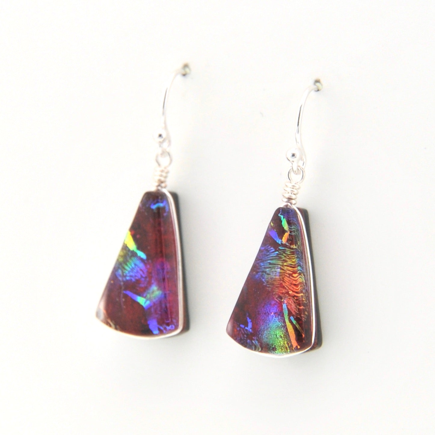 Multicolored triangular earrings on a white background