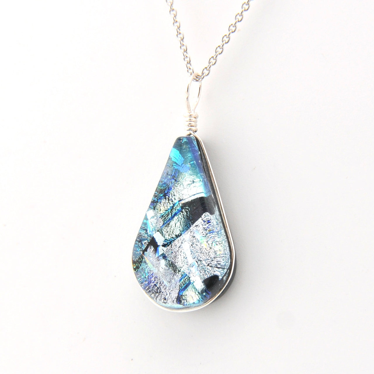 Teardrop-shaped pendant with a blue and silver design on a white background