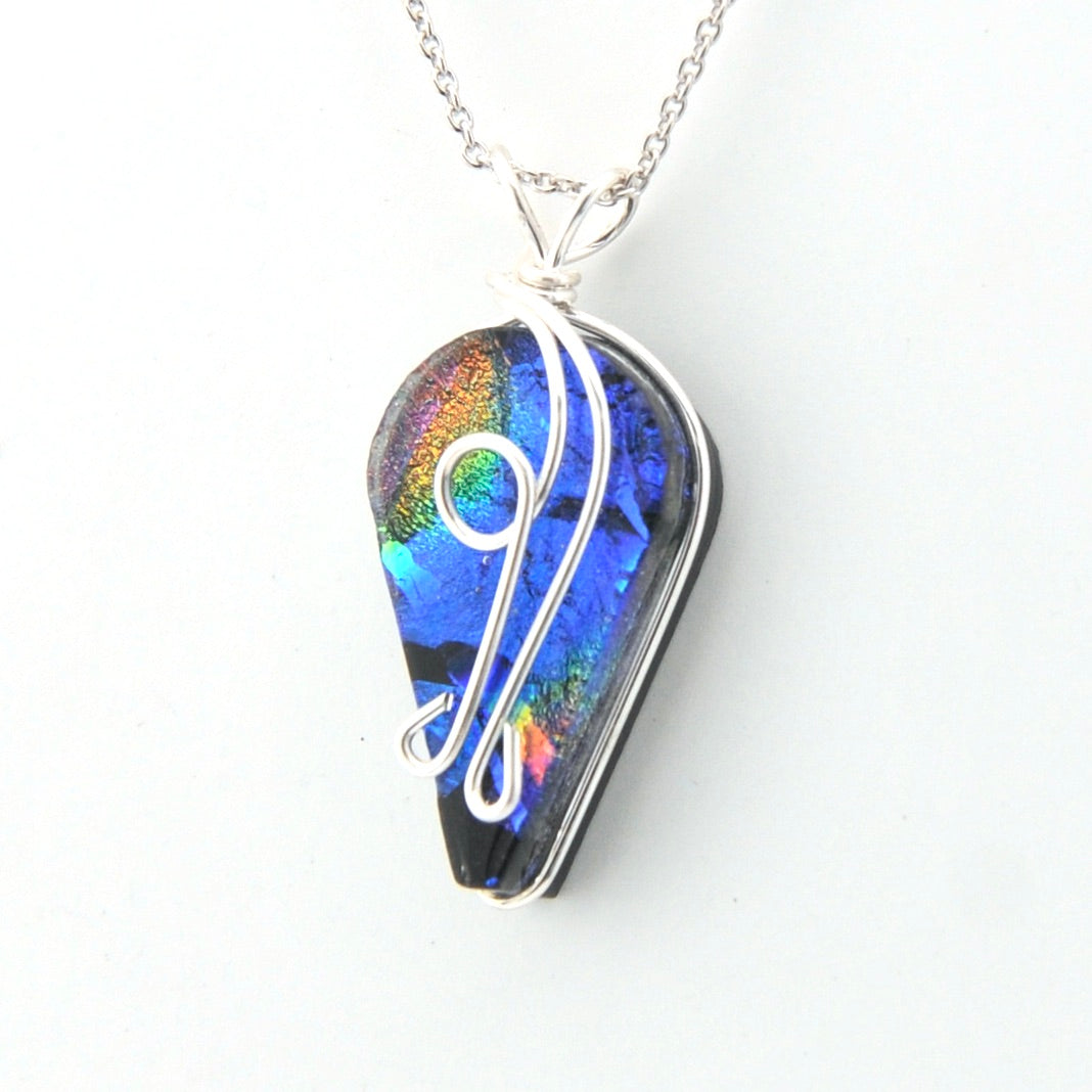Multicolored pendant with a silver chain on a white background