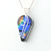 Multicolored pendant with a silver chain on a white background