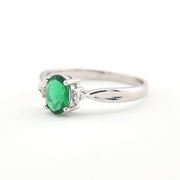 Silver ring with a green gemstone on a white background