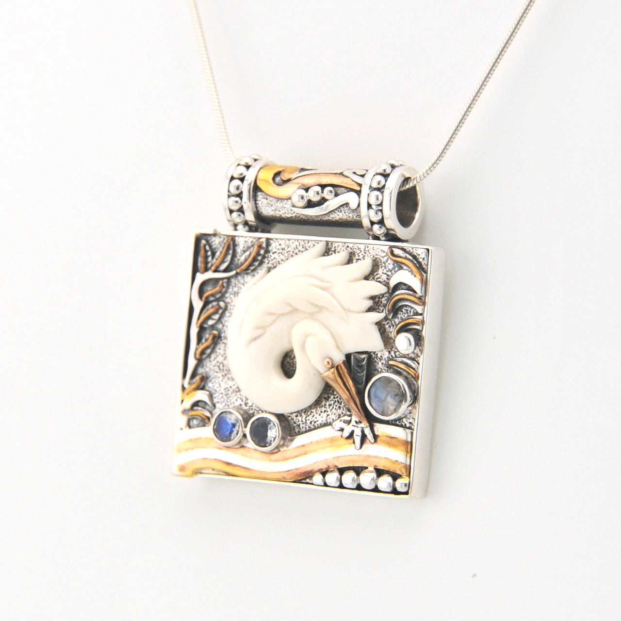 Decorative pendant with a egret design on a white background