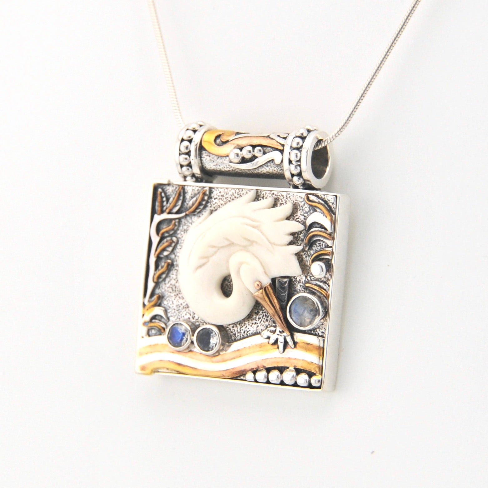 Decorative pendant with a egret design on a white background