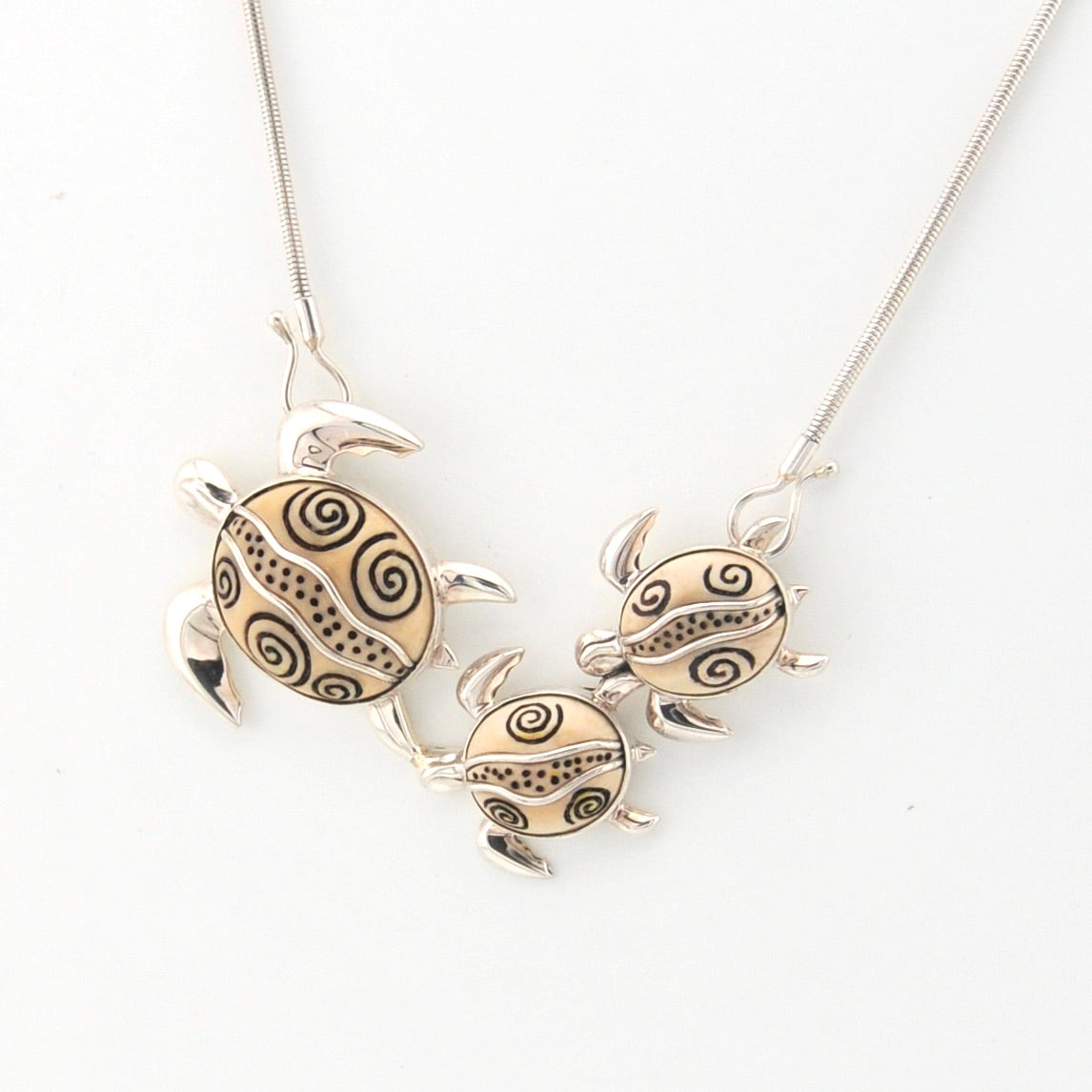 Necklace with turtle-shaped pendants on a white background
