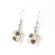 Tortoise-shaped earrings with spiral patterns on a white background