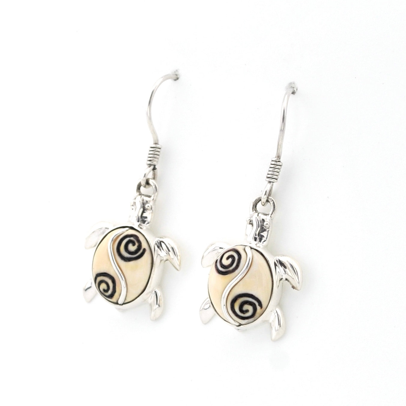 Tortoise-shaped earrings with spiral patterns on a white background