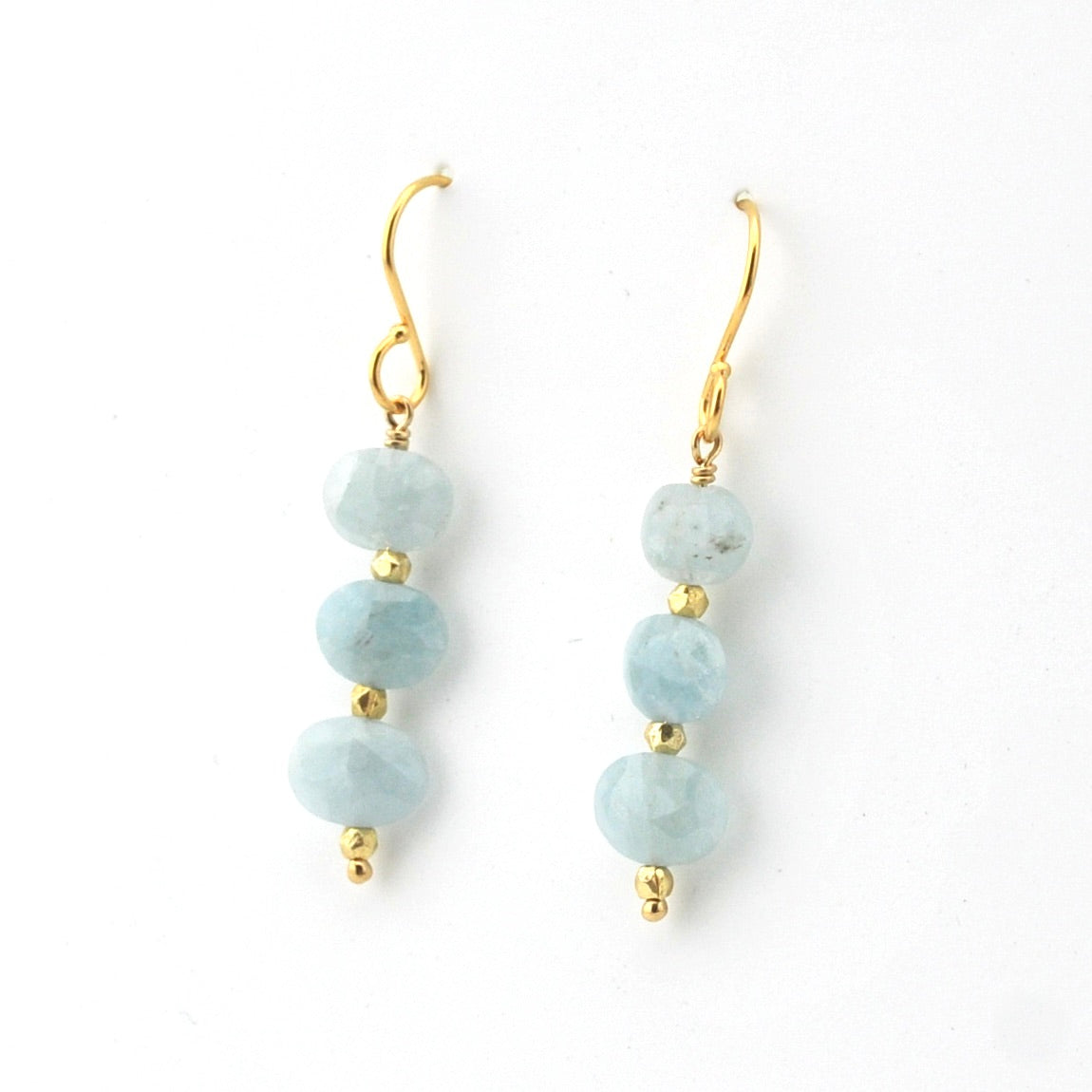 Pair of earrings with light blue beads and gold accents on a white background